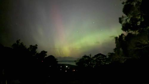 an aurora in the sky over a body of water at Mount Rumney Escapes Seaview House 2 - Eagle House in Mount Rumney