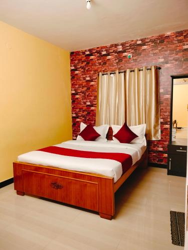 a bedroom with a bed with a brick wall at Harvest Hill View Cottage in Ooty