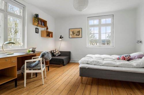 a bedroom with a bed and a desk and a chair at 20129-samso-Landevejen-32 in Nordby