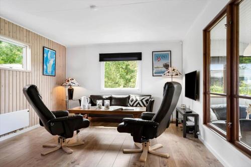 a living room with two chairs and a table at 20221-Samso-Violvej-8 in Tanderup
