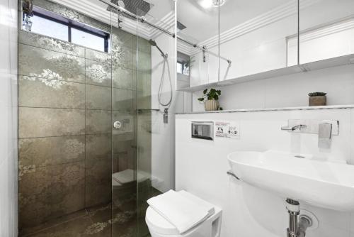 a bathroom with a sink and a toilet and a shower at Cozy Double Room in Glenfield - Centrally Located - Shared Bathroom in Glenfield
