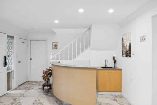 a living room with a staircase and white walls at Cozy Double Room in Glenfield - Centrally Located - Shared Bathroom in Glenfield