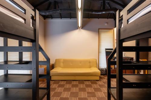 a living room with a couch and a bunk bed at SHINJUKU Garden-house in Tokyo