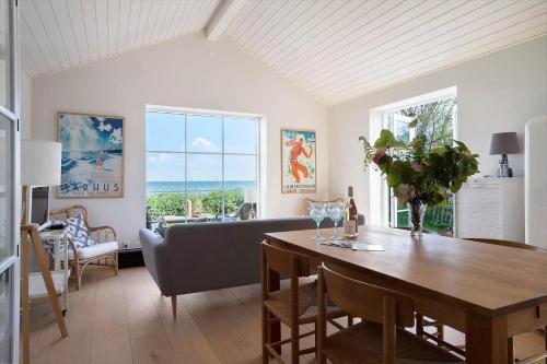a living room with a table and a couch at 20414-Samso-Strandvejen-63 in Ballen