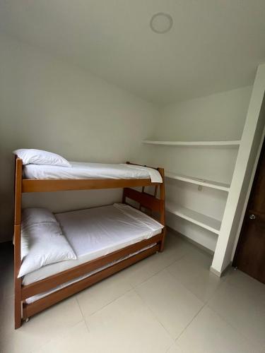 a small room with two bunk beds in it at Sunset Private Villa in Ricaurte in Llano del Pozo