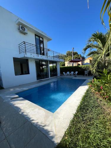 a swimming pool in front of a house at Sunset Private Villa in Ricaurte in Llano del Pozo