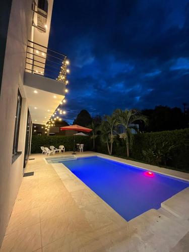 a swimming pool in a backyard at night at Sunset Private Villa in Ricaurte in Llano del Pozo