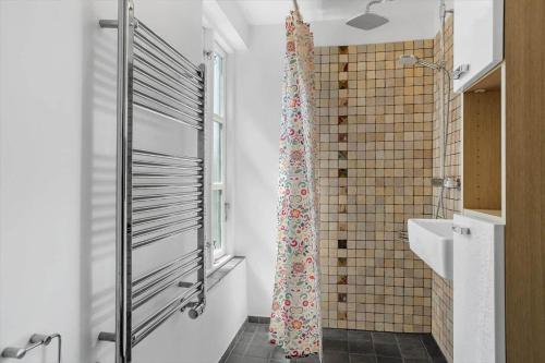 a bathroom with a shower curtain and a sink at 20310-Ballen-Strandvejen-8 in Ballen