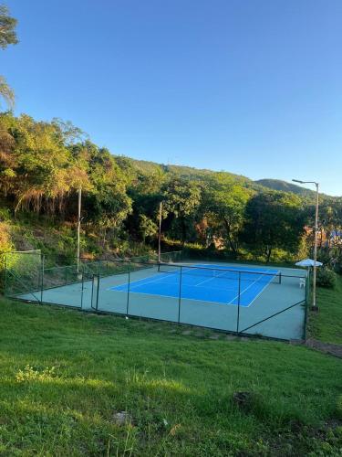 a tennis court in the middle of a field at Sunset Private Villa in Ricaurte in Llano del Pozo