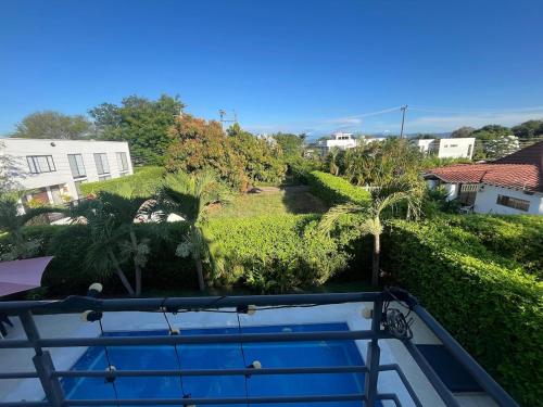 a view from the balcony of a house with a swimming pool at Sunset Private Villa in Ricaurte in Llano del Pozo