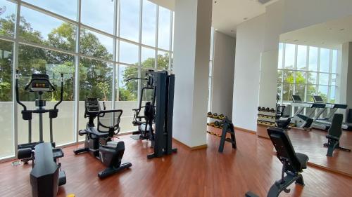 a gym with treadmills and exercise bikes in a room at REOTEL at THE NOVE - NUVASA BAY serviced Apartment in Pulau Nongsa