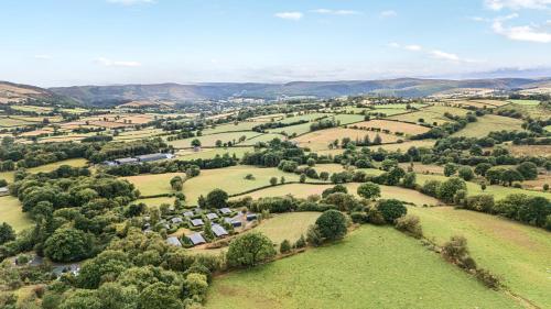 an aerial view of a village in the hills at Valley View in Rhayader