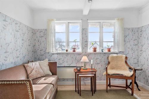 a living room with a couch and a chair at 20304-Samso-Orby-Hovedgade-35 in Brundbymark