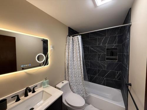 a small bathroom with a toilet and a sink at Luxury Mountain Getaway - 6 bed, 3 bath, hot-tub, fire-pit, game-room in Hunter