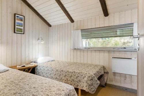 a room with two beds and a window at 20223-Samso-Rosenvej-8 in Tanderup