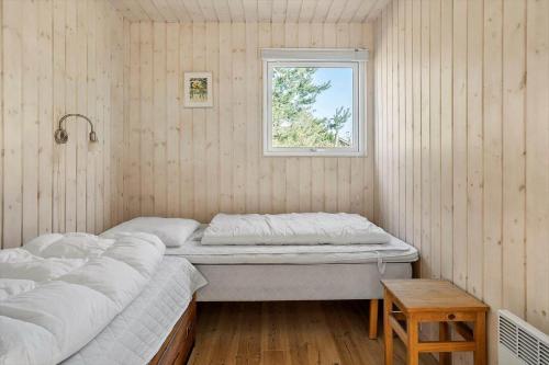 a bedroom with two beds and a window at 20109-Samso-Rosenvej-88 in Tanderup