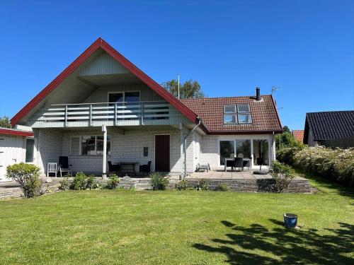 a white house with a red roof and a yard at 20416-Samso-Strandvejen-10-A in Ballen