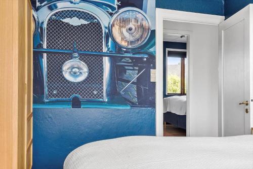 a bedroom with a blue wall with a car on it at 20328-Samso-Besservej-35 in Tranebjerg