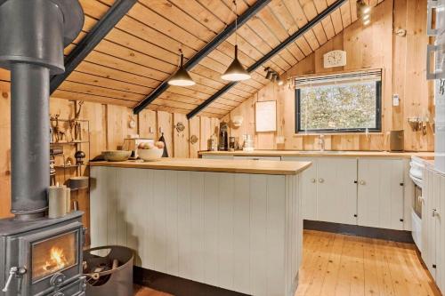 a kitchen with a stove in the middle of a room at 20114-Samso-Blamejsevej-9 in Nordby
