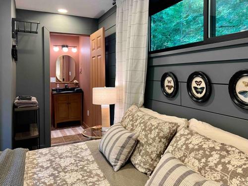 a bedroom with a bed and a window and a sink at Gwen's Cottage at Water's Edge in Portersville
