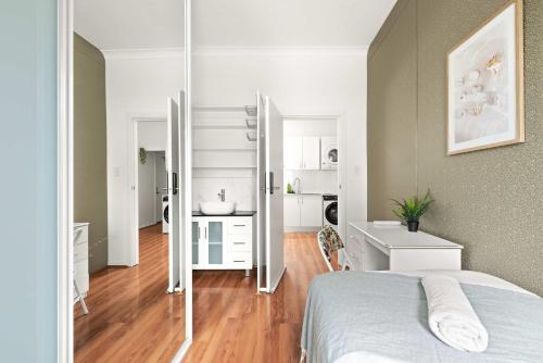 a bedroom with a bed and a bathroom at Single Room - Private Spot in Kingsford - Convenient Location - Shared Bathroom in Sydney