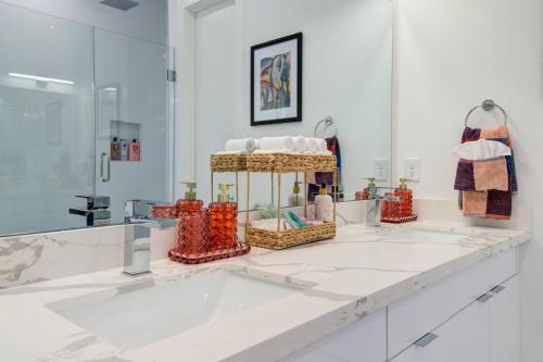 a bathroom with a white counter with a sink at HoustonHideaway 3BR/3.5BA near UH BBQ & Pool Table in Houston