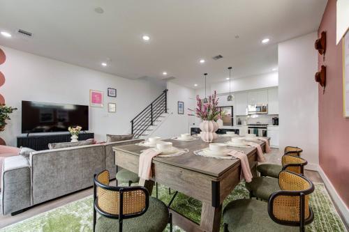 a dining room with a table and chairs at HoustonHideaway 3BR/3.5BA near UH BBQ & Pool Table in Houston