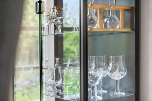 a bunch of wine glasses sitting on a shelf at 20329-Samso-Smedegade-8 in Tranebjerg
