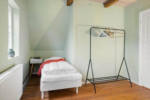 a room with a white bed and a lamp at 20329-Samso-Smedegade-8 in Tranebjerg