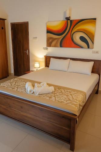 a bedroom with a bed with towels on it at Ranaya Residence Kandy in Kandy