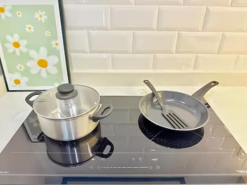 a pot and a pan on a stove top at Iconic Regency Penang in Bayan Lepas