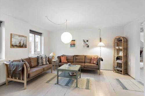 a living room with a couch and a table at AE284-Aeroskobing-Gyden-13 in Ærøskøbing