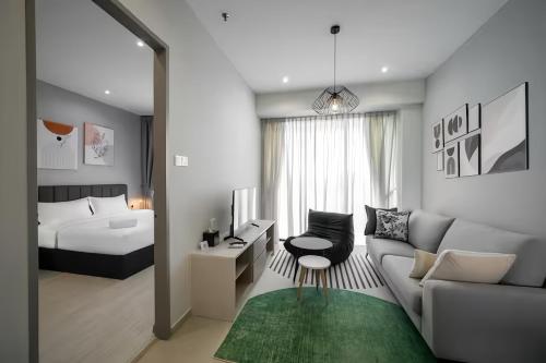 a living room with a couch and a bed at Iconic Regency Penang in Bayan Lepas