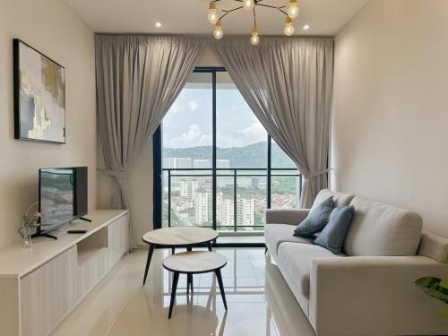 a living room with a couch and a table at Iconic Regency Penang in Bayan Lepas