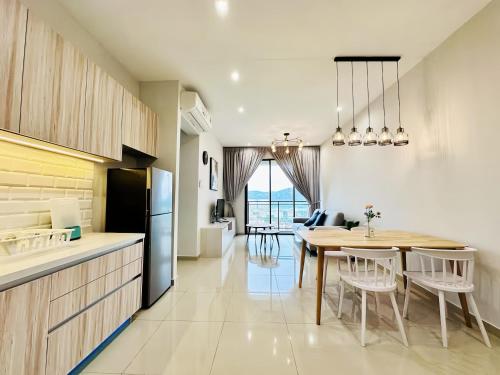 a kitchen and dining room with a table and chairs at Iconic Regency Penang in Bayan Lepas