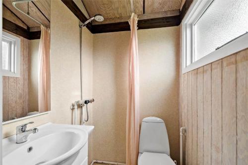 a bathroom with a sink and a toilet and a mirror at SB50361-Nordborg-Krabbestien-11 in Nordborg