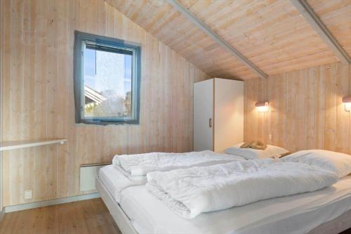 a large white bed in a room with a window at SB113-Sydals-Oddermosen-11 in Sønderby