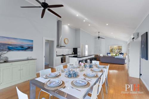 a dining room and kitchen with a table and chairs at Family Home Silverleaves Sleeps 12 in Rhyll