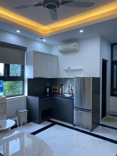 a kitchen with black and white counters and a refrigerator at Luxury Apartment with City View Quang Trung Hadong in Hà Ðông