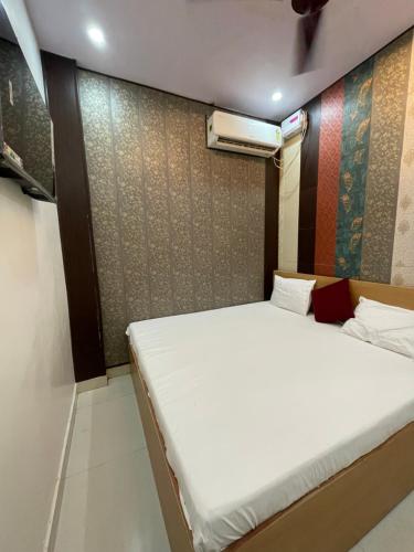 a bed in a room with a white mattress at Kashi Vishweshwar Guest House in Varanasi