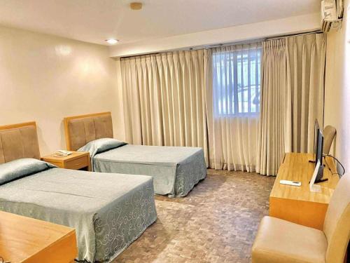 Ένα ή περισσότερα κρεβάτια σε δωμάτιο στο Bayfront Hotel Subic