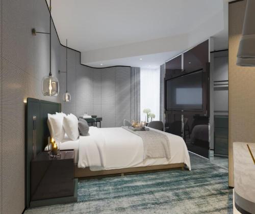 a bedroom with a white bed and a flat screen tv at The Harbourview - Chinese YMCA of Hong Kong in Hong Kong