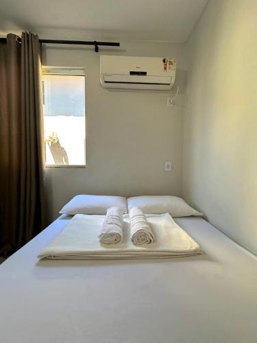 a bed in a room with two towels on it at Apartamento Próximo ao Aeroporto e Rodoviária in Palmas