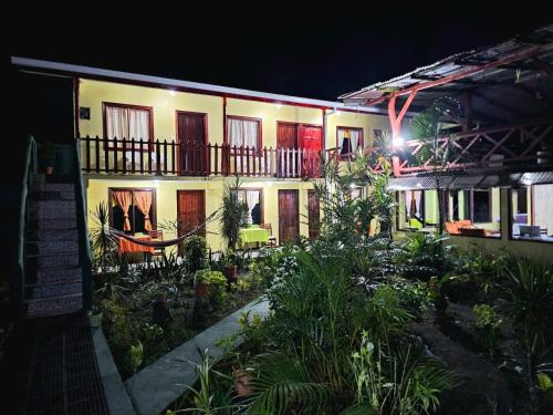 a building with a lot of plants in front of it at Cabinas Miss Miriam 2 in Tortuguero