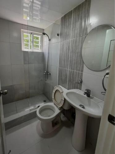a bathroom with a toilet and a sink and a shower at Martina II Stay in Santo Domingo