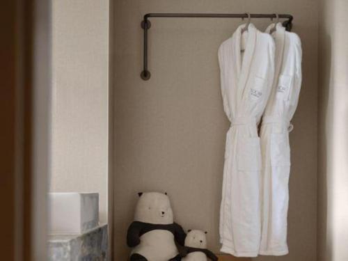 two teddy bears are sitting next to a shower curtain at Immersing Hotel Guilin Two Rivers and Four Lakes Dongxi Alley in Guilin