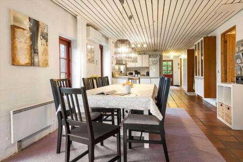 a kitchen and dining room with a table and chairs at 20145-Samso-Skovvejen-14 in Nordby