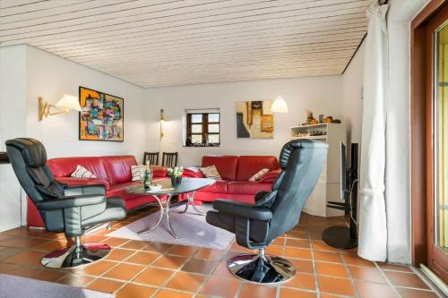 a living room with a red couch and a table at 20145-Samso-Skovvejen-14 in Nordby
