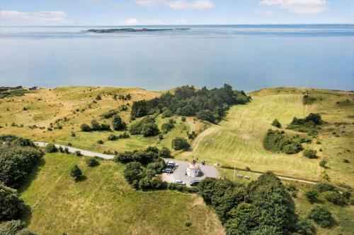 an aerial view of a house on a hill next to the water at 20145-Samso-Skovvejen-14 in Nordby