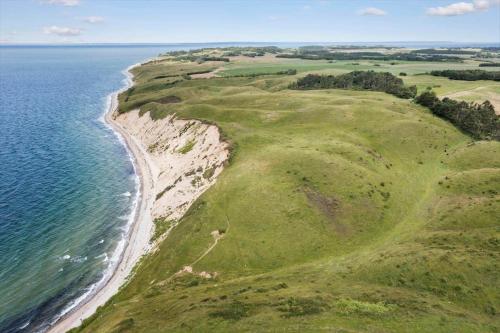 an aerial view of a golf course and the ocean at 20145-Samso-Skovvejen-14 in Nordby